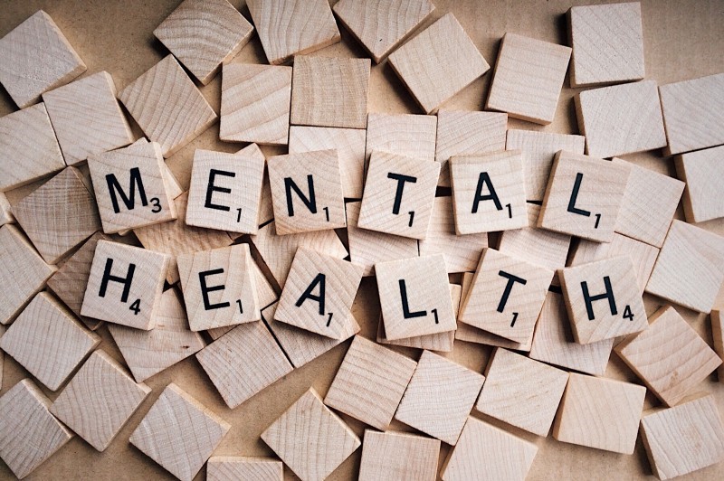 a pile of wooden blocks spelling out the words mental health